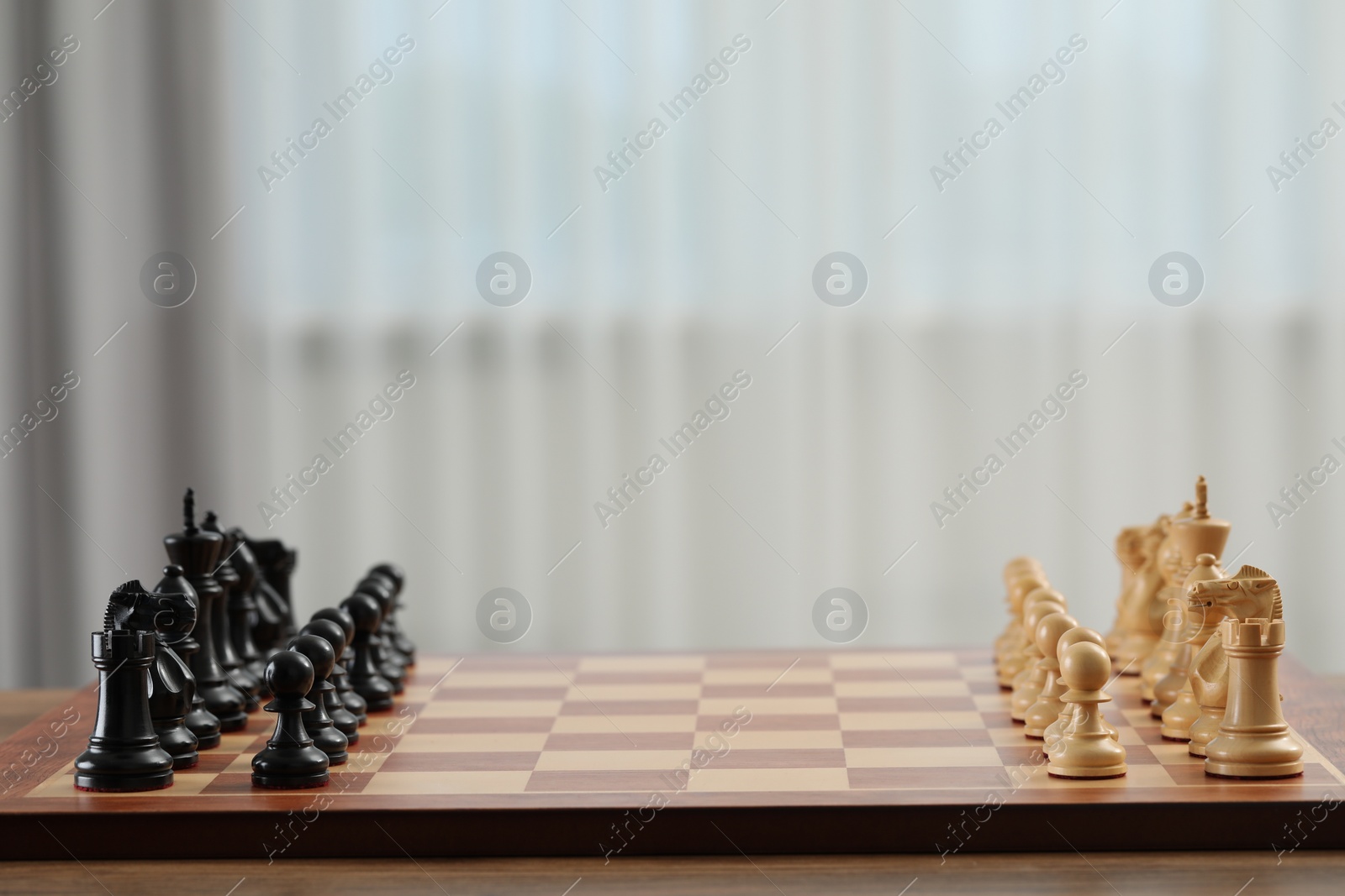 Photo of Set of chess pieces on checkerboard before game, selective focus. Space for text