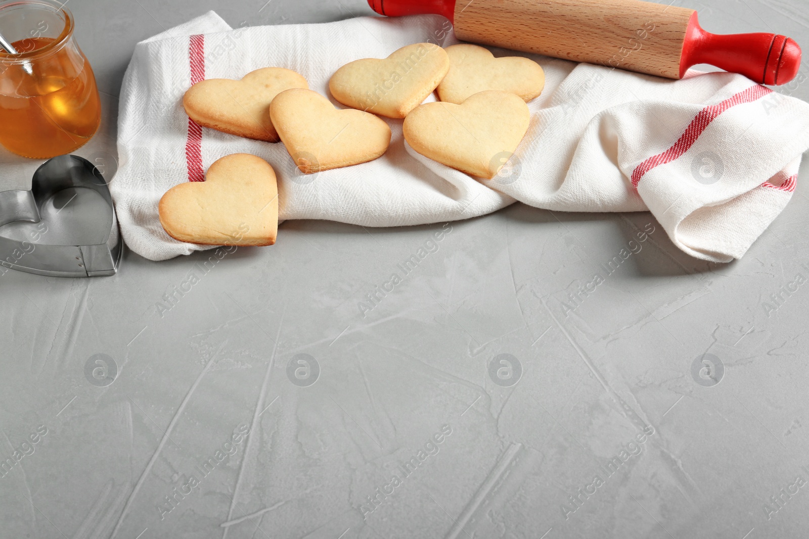 Photo of Composition with heart shaped cookies and space for text on table