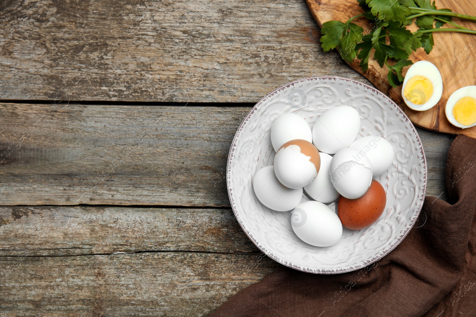 Photo of Flat lay composition with boiled eggs on wooden table. Space for text