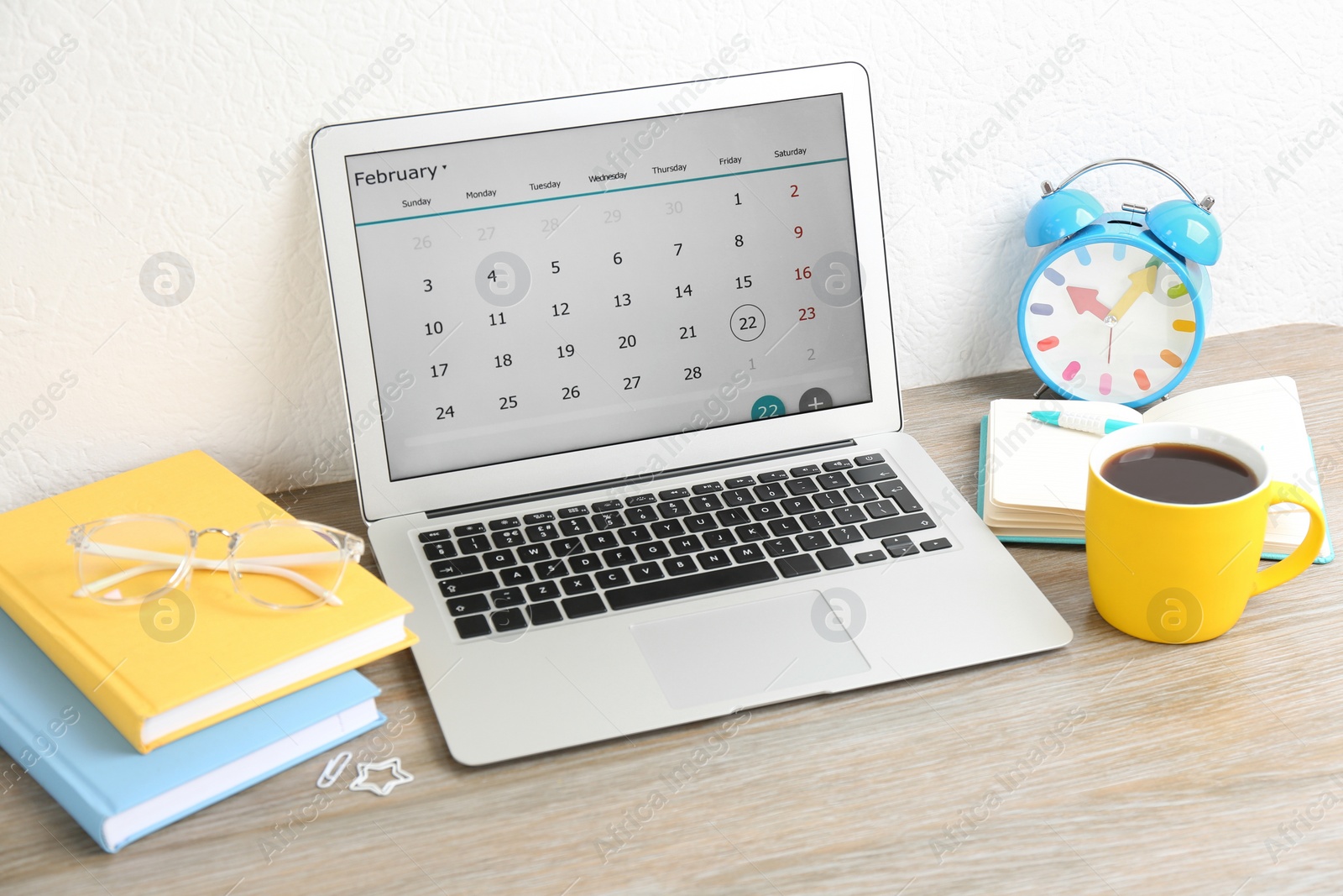 Photo of Modern laptop with calendar app in office