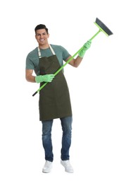 Man with green broom on white background