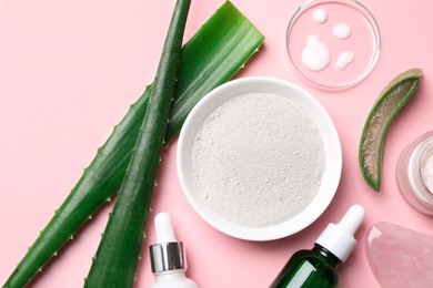 Flat lay composition with cosmetic products and cut aloe leaves on pink background