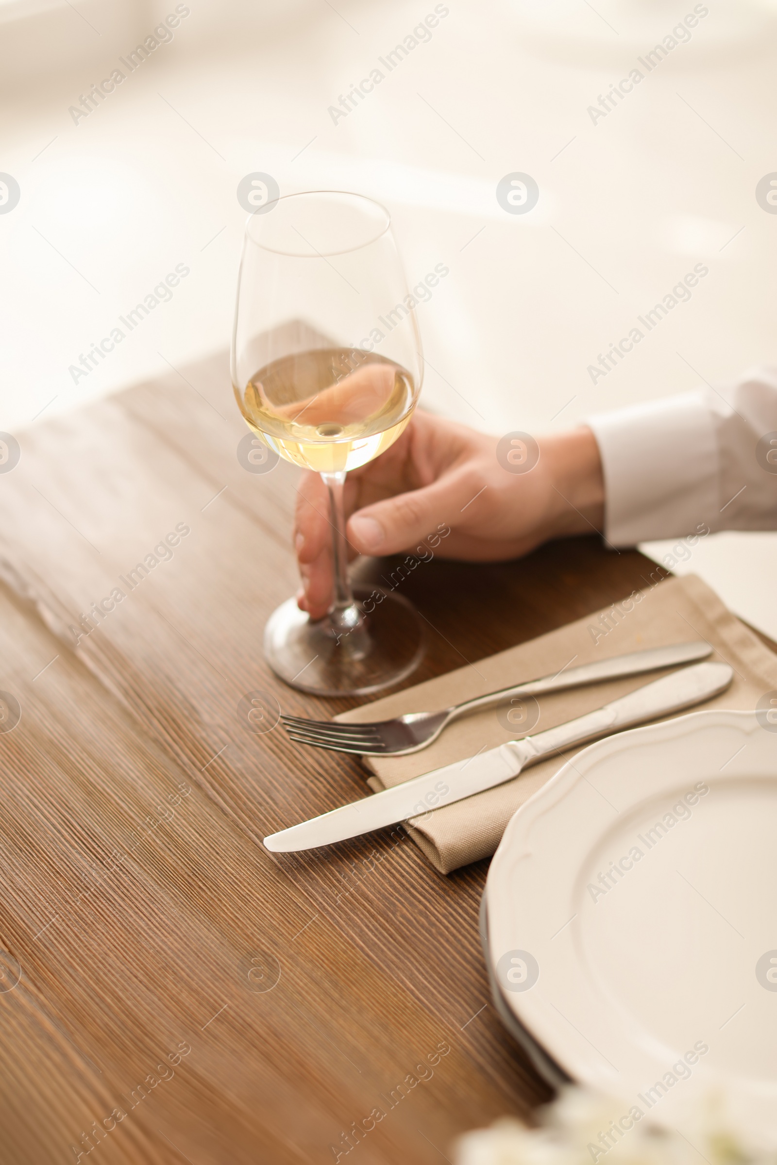 Photo of Man with glass of wine at table in restaurant