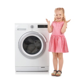 Photo of Cute little girl standing near washing machine on white background. Laundry day