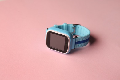 Photo of Modern trendy smart watch for kids on pink background