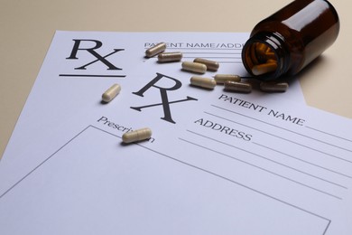 Photo of Medical prescription forms, pills and bottle on beige background, closeup