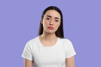 Tired young woman on purple background. Insomnia problem
