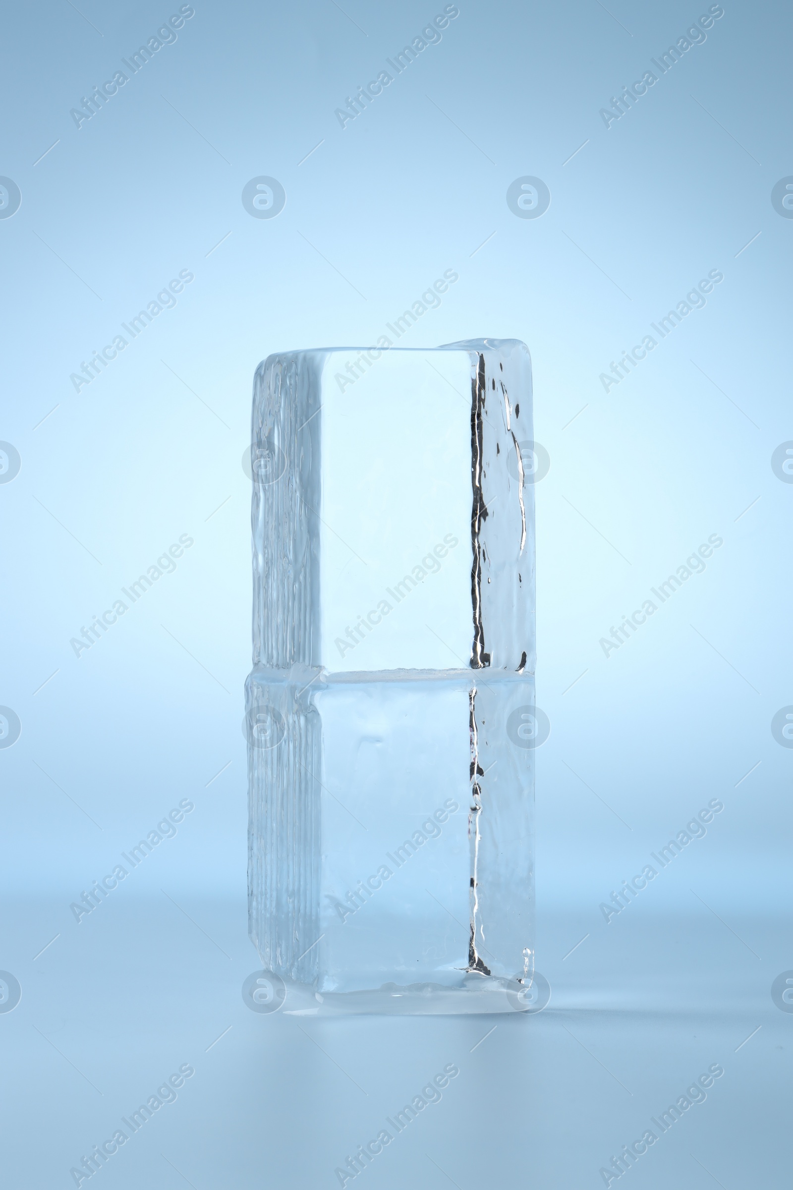 Photo of Blocks of clear ice on light blue background