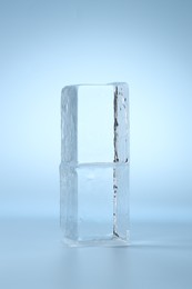 Blocks of clear ice on light blue background