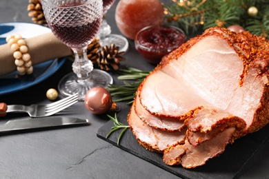 Delicious Christmas ham served on dark table