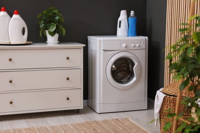 Laundry room interior with washing machine and furniture