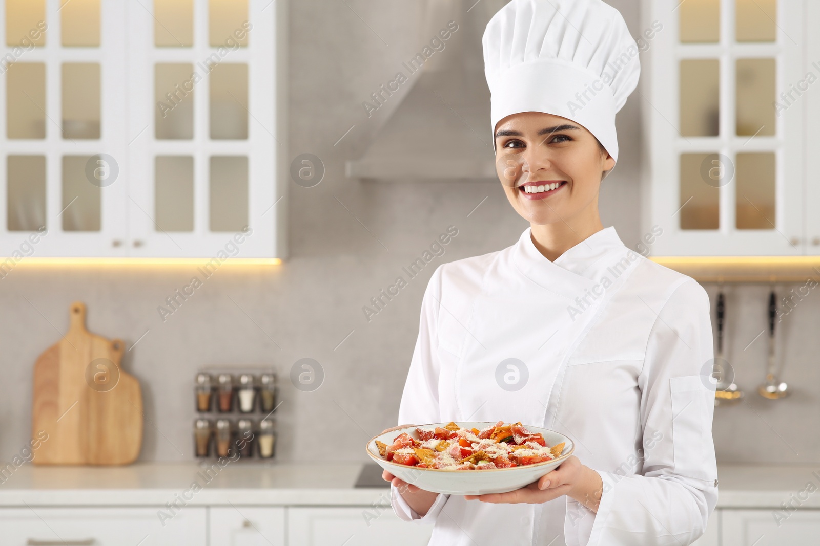 Photo of Portrait of professional chef presenting delicious dish in kitchen. Space for text