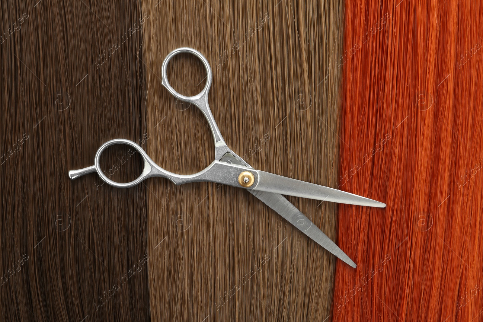 Photo of Scissors on hair, top view. Hairdresser service