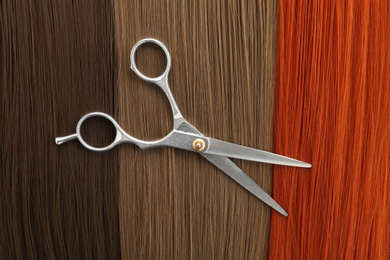 Scissors on hair, top view. Hairdresser service