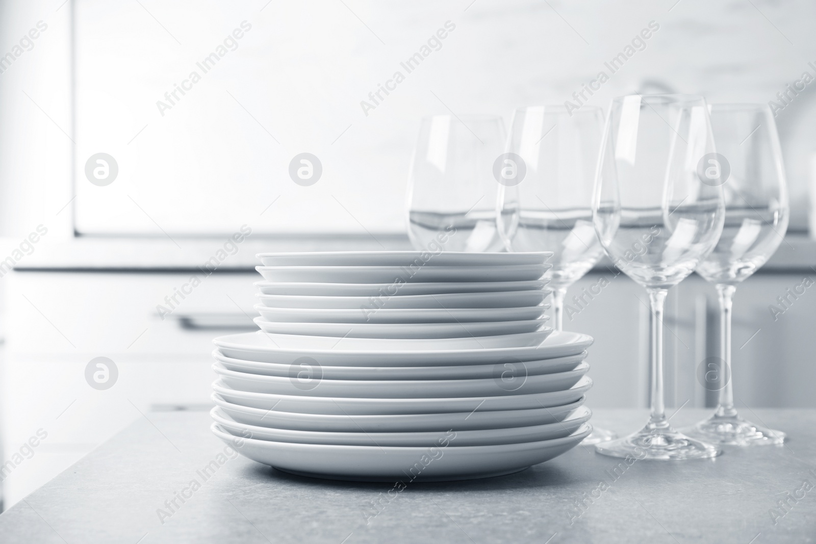Photo of Set of clean dishes on table in kitchen