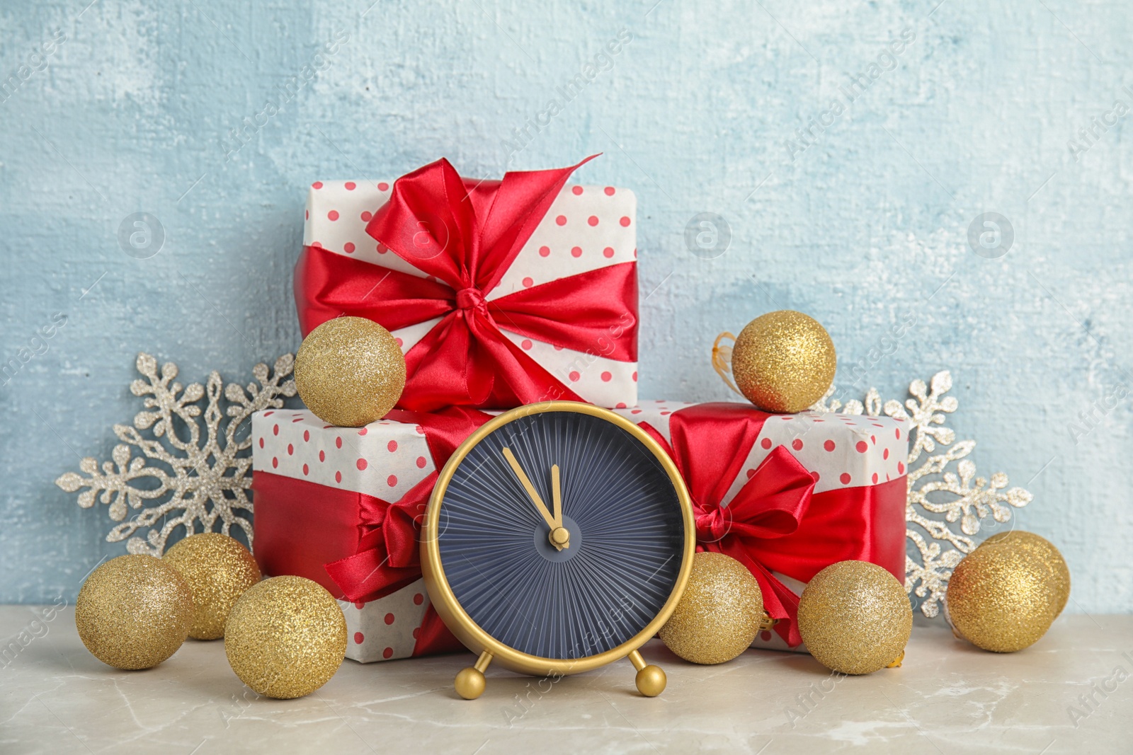 Photo of Alarm clock, gifts and decorations on table. Christmas countdown