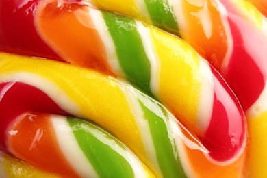 Photo of Sweet colorful lollipop on light background, closeup view. Delicious candy