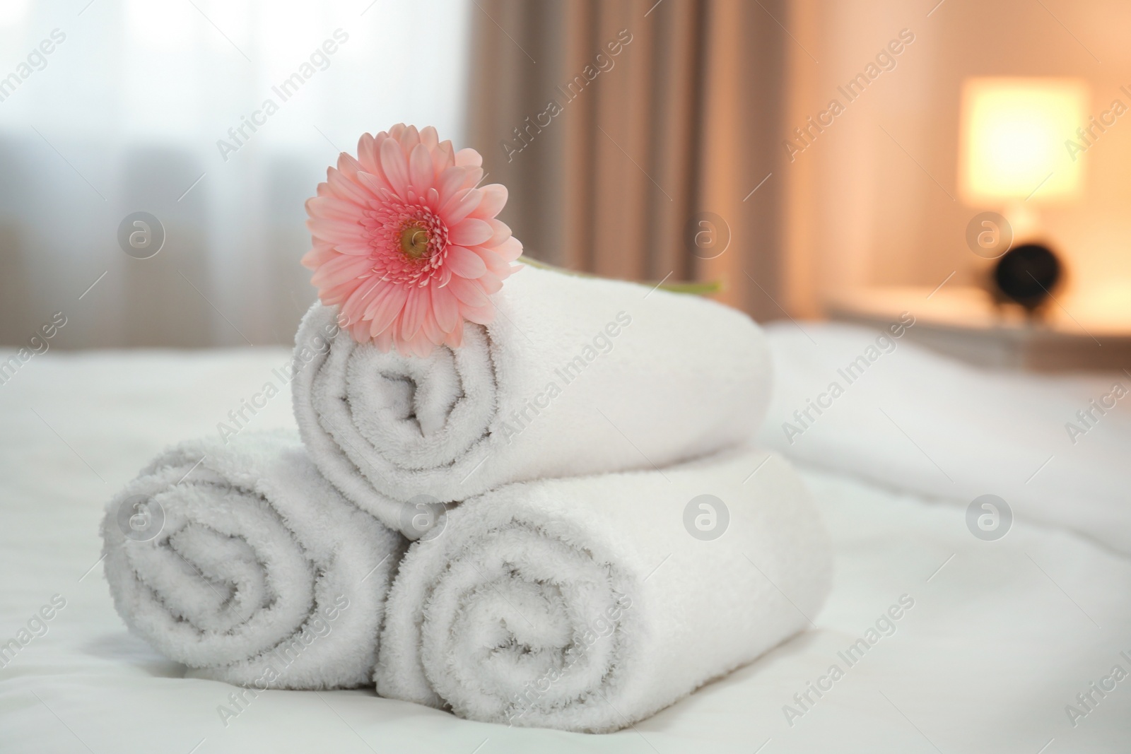 Photo of Clean towels on bed in hotel room