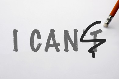 Image of Phrase I CAN'T with crossed out letter T and pencil on white background. Motivation and positivity