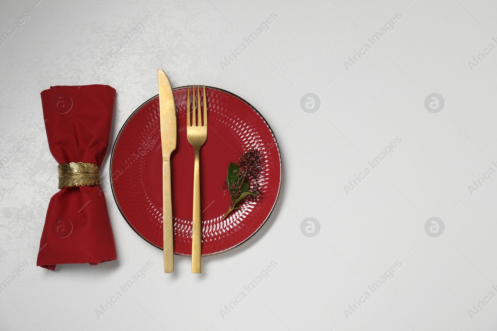 Photo of Stylish setting with elegant cutlery on white table, top view. Space for text