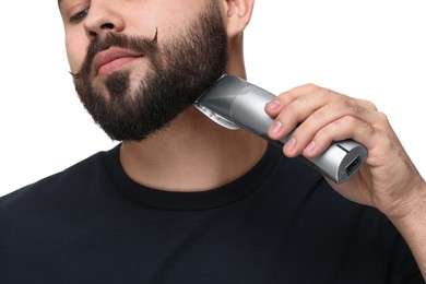 Photo of Handsome young man trimming beard on white background, closeup