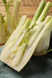 Photo of Cut raw fennel bulbs on table, closeup