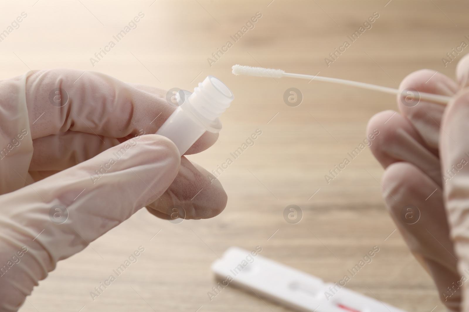 Photo of Doctor making laboratory testing at wooden table, closeup
