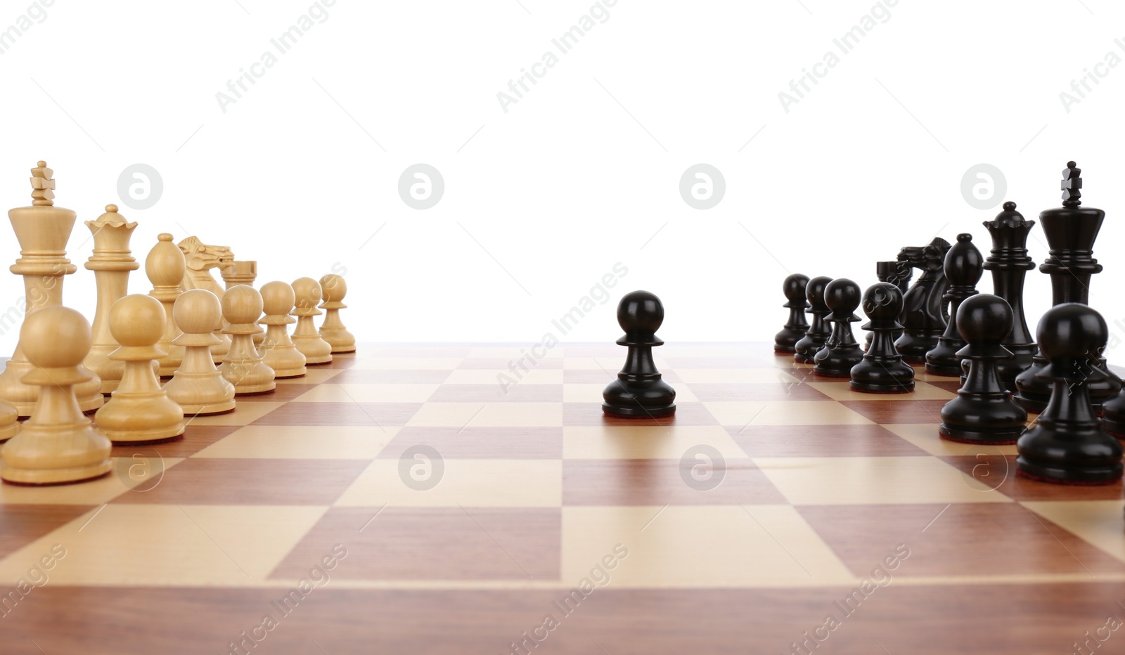 Photo of Chess pieces on wooden board against white background