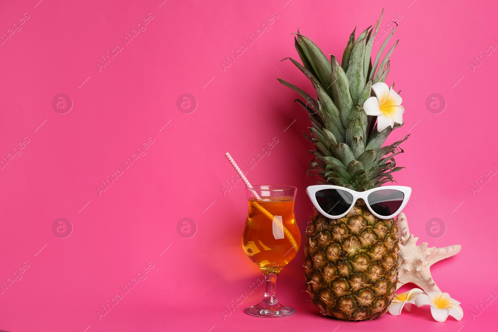 Photo of Funny pineapple with cocktail, plumeria flowers and starfish on pink background, space for text. Creative concept