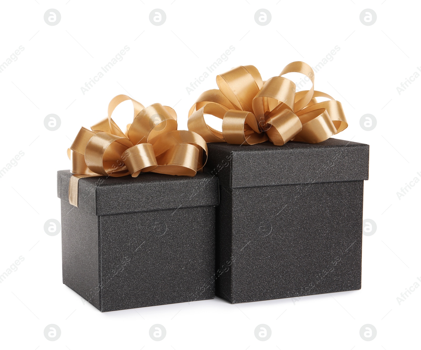 Photo of Black gift boxes with golden bows on white background