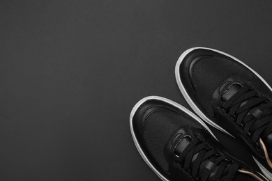 Photo of Pair of stylish shoes on black background, top view. Space for text