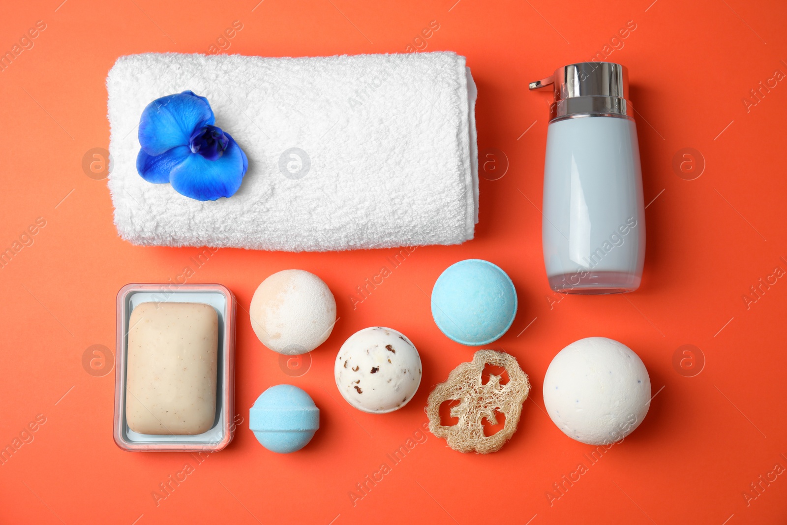 Photo of Flat lay composition with bath bombs and toiletries on color background