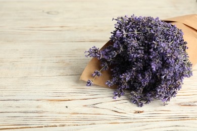Photo of Beautiful lavender bouquet on white wooden table, closeup. Space for text