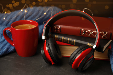 Photo of Books, coffee and headphones on grey table