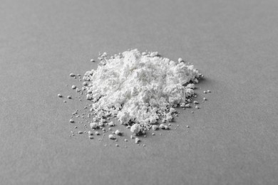Heap of calcium carbonate powder on grey table