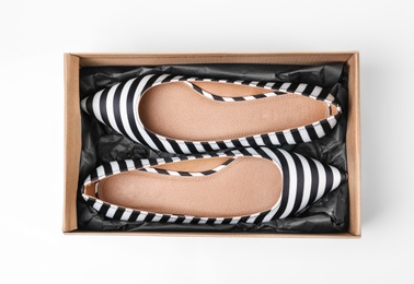 Pair of female shoes in box on white background, top view