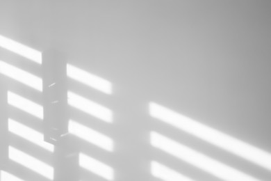Image of Light and shadows falling on white wall