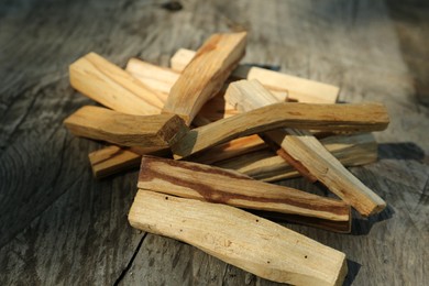 Photo of Palo santo sticks on wooden table, closeup