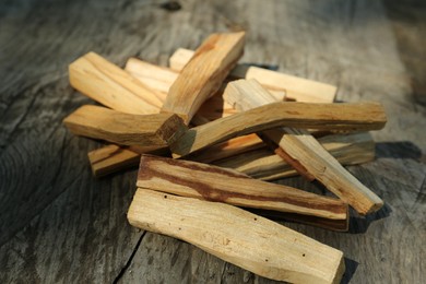 Palo santo sticks on wooden table, closeup