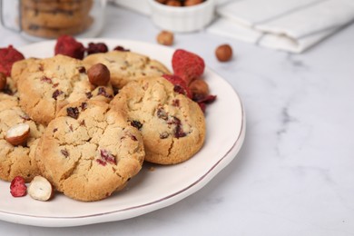 Photo of Cookies with freeze dried fruits and nuts on white marble table, closeup. Space for text