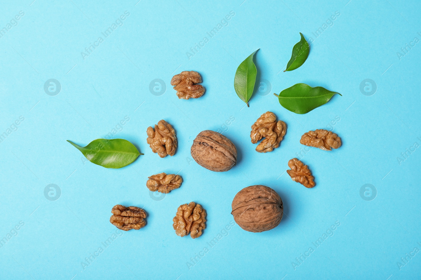 Photo of Flat lay composition with tasty walnuts on color background