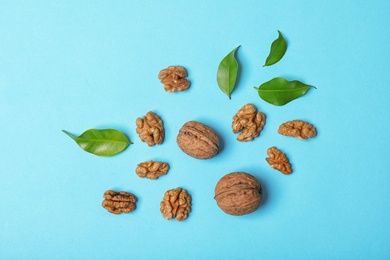 Flat lay composition with tasty walnuts on color background