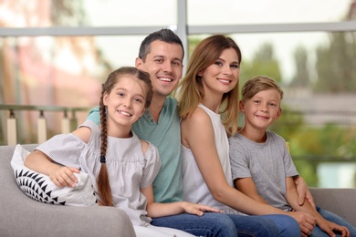 Happy family with cute children at home