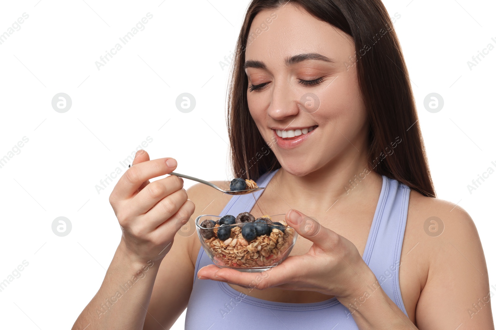 Photo of Happy woman eating tasty granola with fresh berries on white background