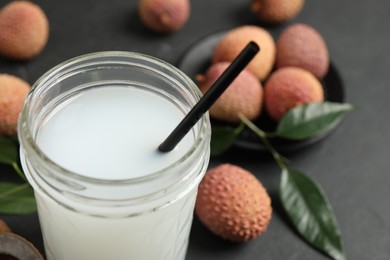 Photo of Freshly made lychee juice on grey table, closeup. Space for text