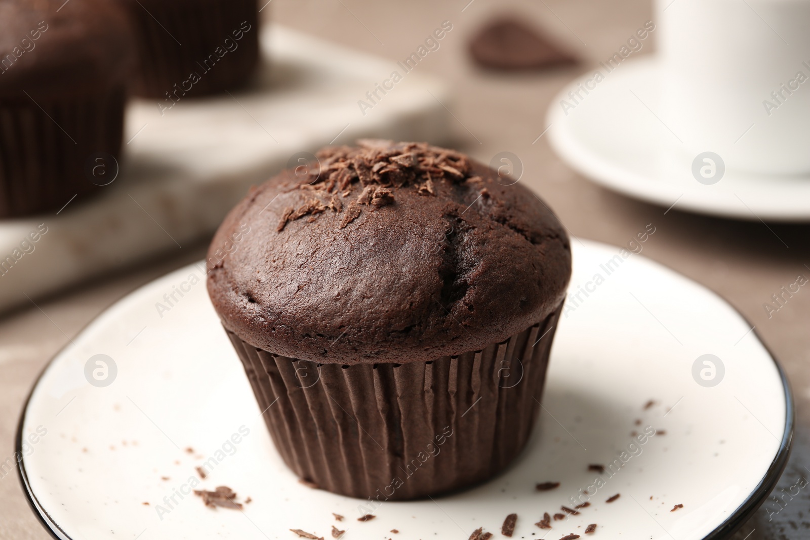 Photo of Delicious cupcake with chocolate crumbles on plate, closeup
