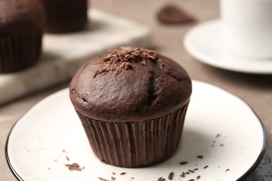 Photo of Delicious cupcake with chocolate crumbles on plate, closeup