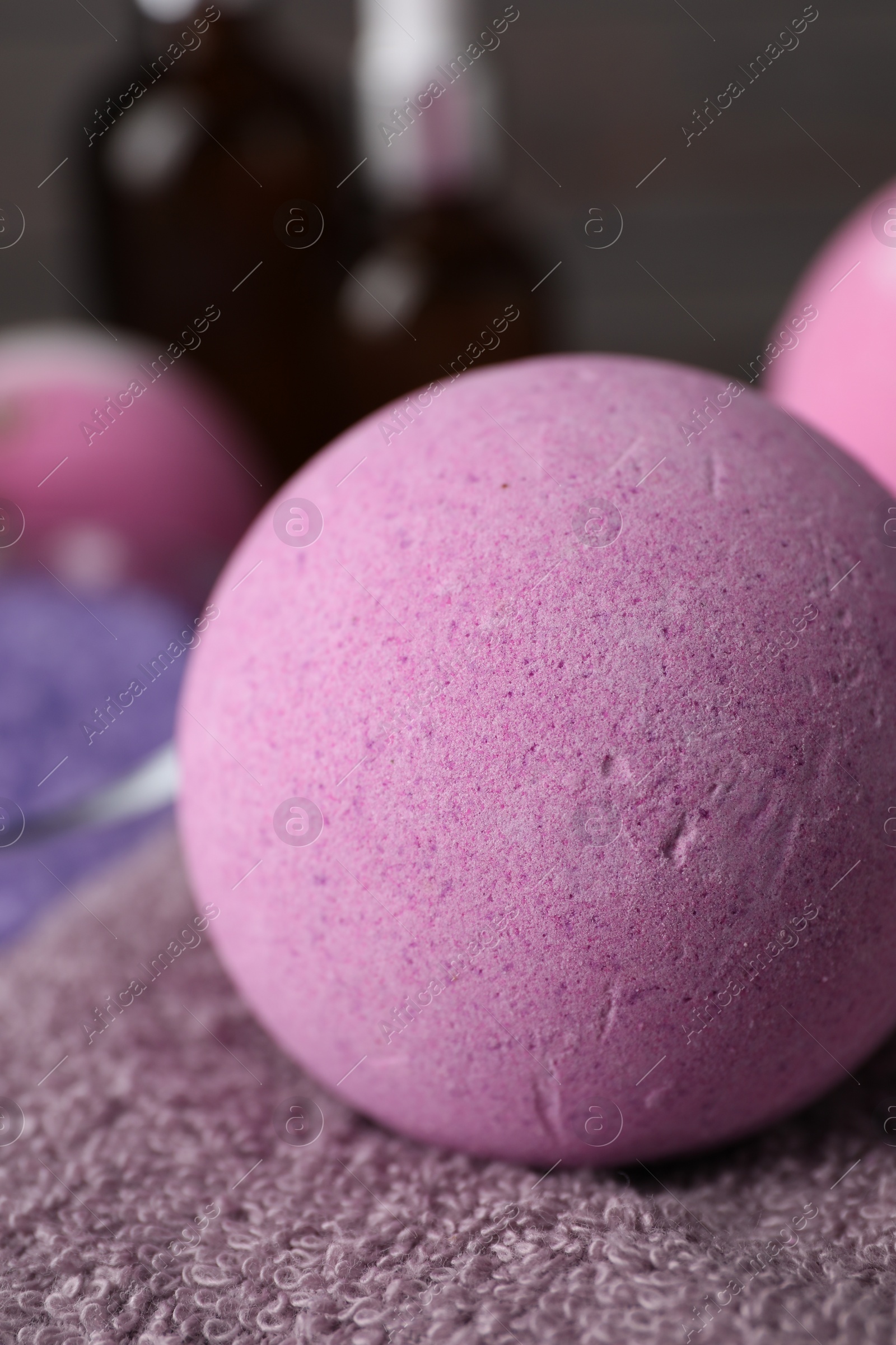Photo of Beautiful aromatic bath bomb on soft towel, closeup