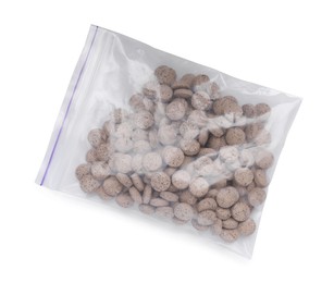 Photo of Brewer's yeast tablets in plastic bag isolated on white, top view