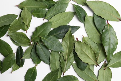 Many fresh bay leaves on white background, flat lay